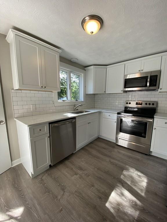 70 Plumtree Circle Springfield, MA 01118 - Photo 9 of 29 a kitchen with stainless steel appliances granite countertop a sink a stove a refrigerator and microwave