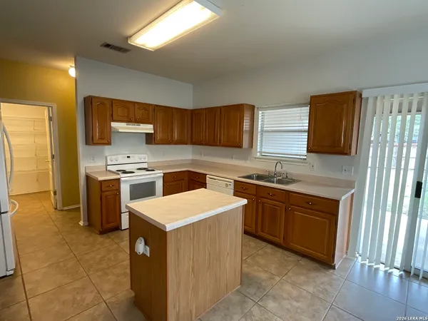a kitchen with a stove a sink and a refrigerator