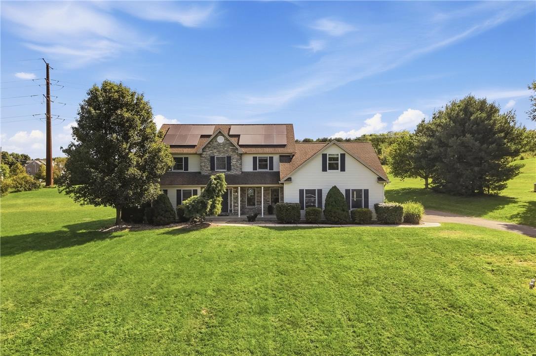 590 Fehr Road Nazareth, PA 18064 - Photo 1 of 79 A spacious green lawn fronts this multi-level home featuring solar panels and stone accents.
