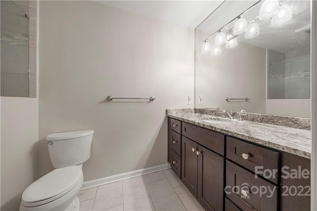 32 Old Post Road Clover, SC 29710 - Photo 13 of 45 a bathroom with a granite countertop toilet sink and mirror