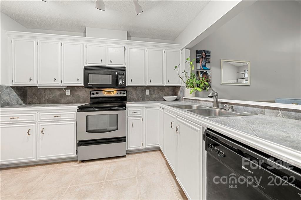 32 Old Post Road Clover, SC 29710 - Photo 26 of 45 a kitchen with granite countertop white cabinets and white appliances
