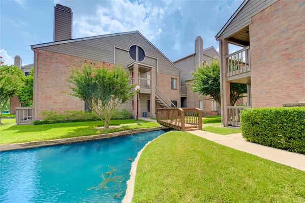a front view of a house with swimming pool having outdoor seating