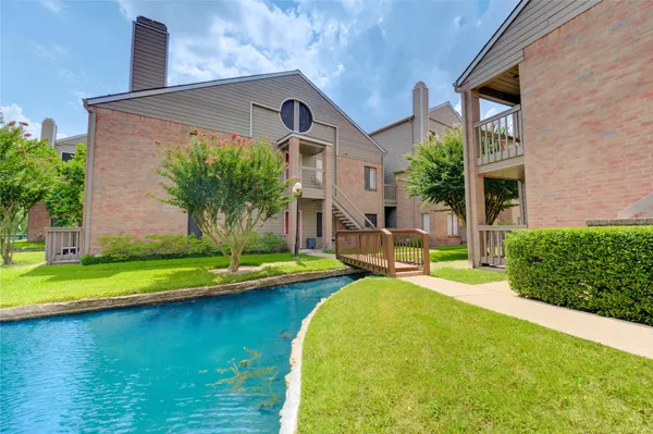 a front view of a house with swimming pool having outdoor seating