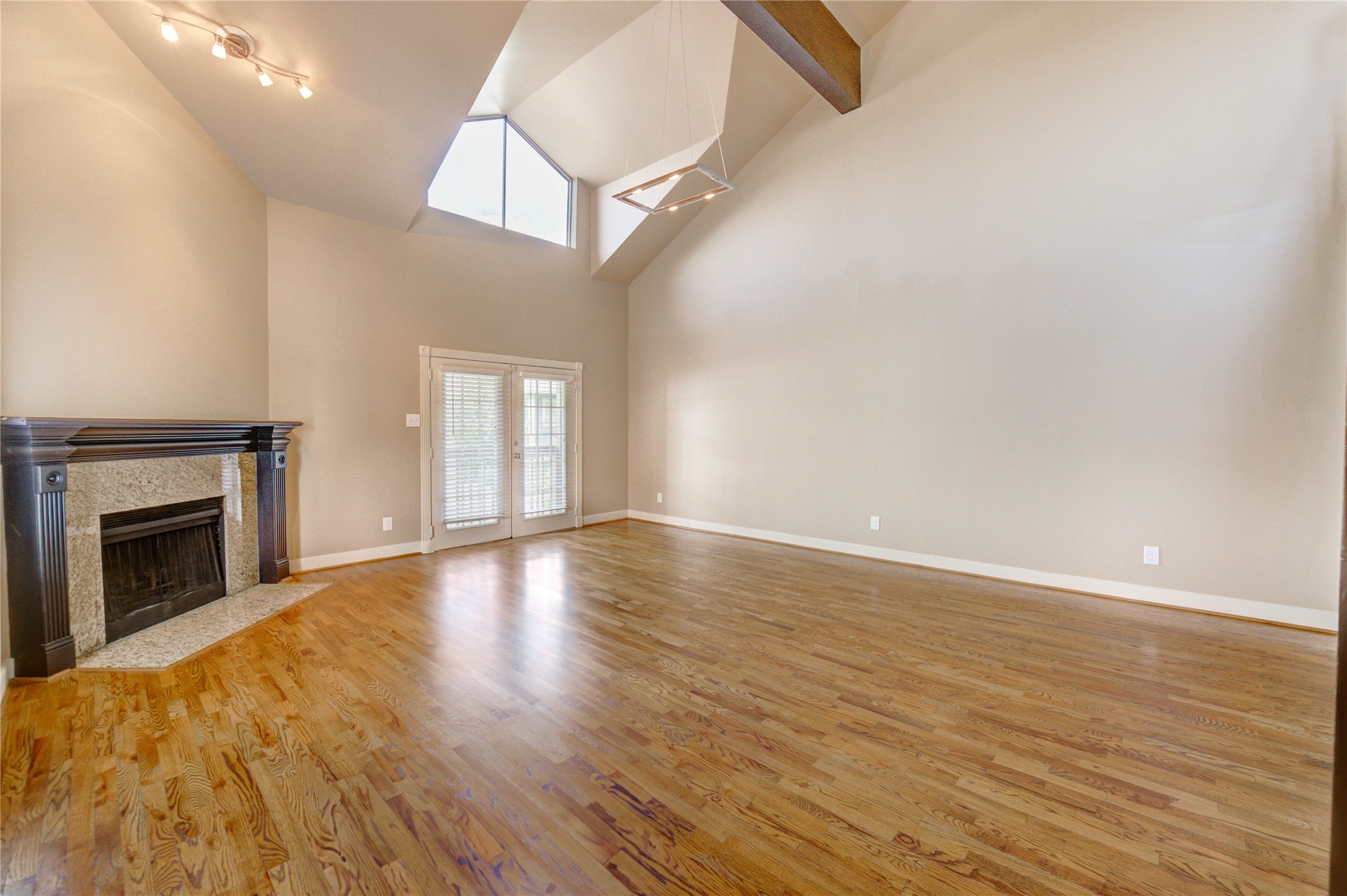 2023 Gentryside Drive, Unit 202 Houston, TX 77077 - Photo 21 of 50 a view of empty room with wooden floor and fireplace