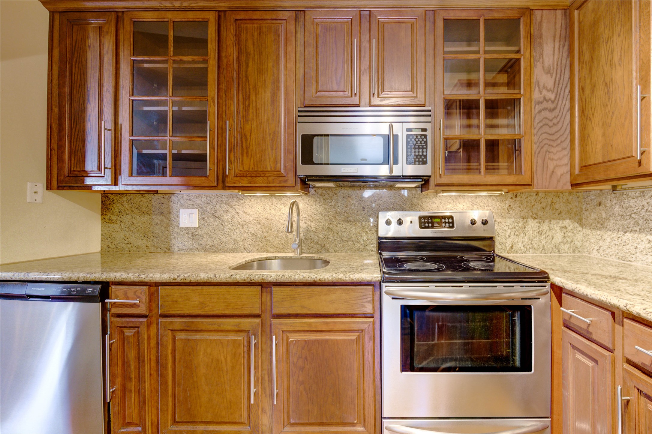 2023 Gentryside Drive, Unit 202 Houston, TX 77077 - Photo 26 of 50 a kitchen with granite countertop cabinets stainless steel appliances and a sink