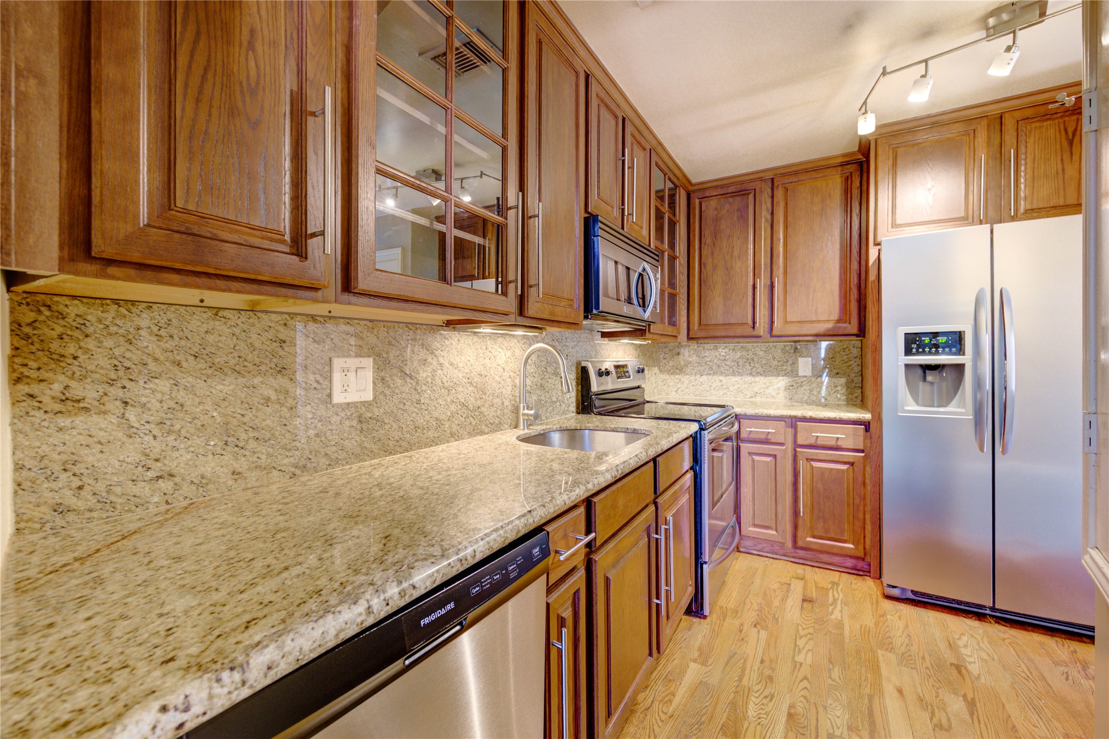 2023 Gentryside Drive, Unit 202 Houston, TX 77077 - Photo 27 of 50 a kitchen with stainless steel appliances granite countertop a refrigerator and a sink