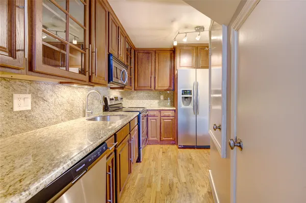 a kitchen with stainless steel appliances granite countertop a sink and cabinets