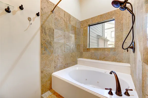 a bathroom with a bathtub and a shower