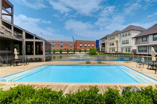 a view of a swimming pool and lounge chairs