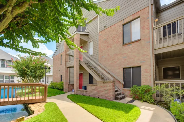 a view of empty room with wooden floor and fireplace