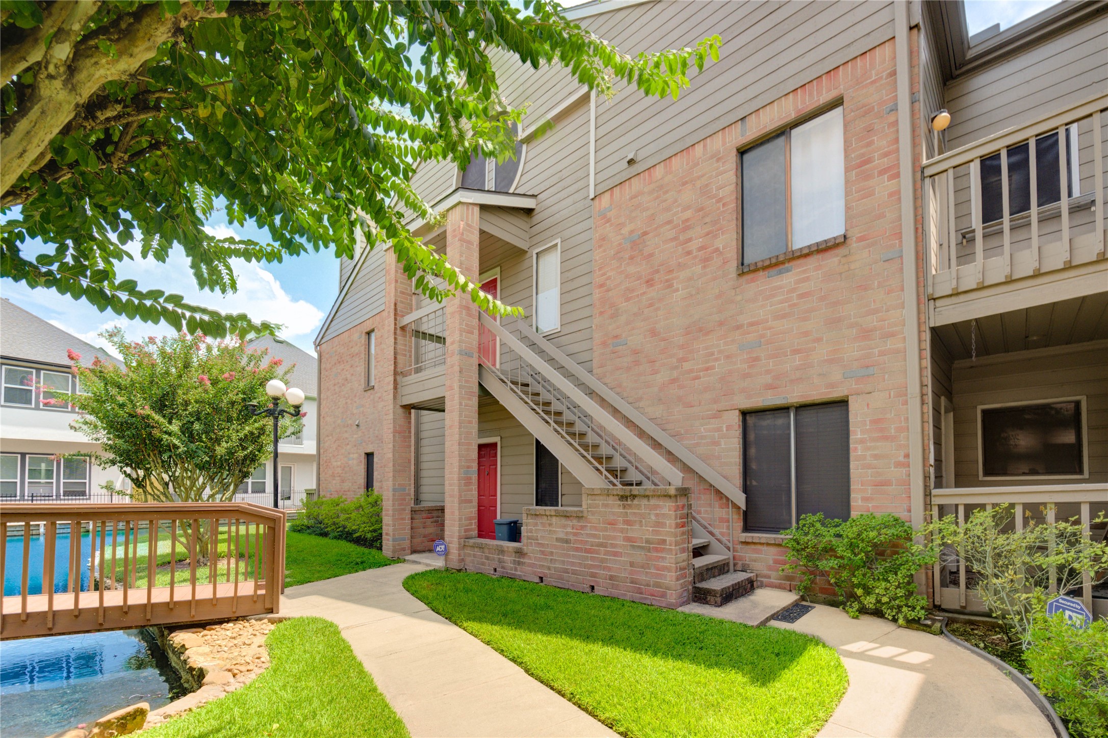 2023 Gentryside Drive, Unit 202 Houston, TX 77077 - Photo 9 of 50 a view of a house with a yard