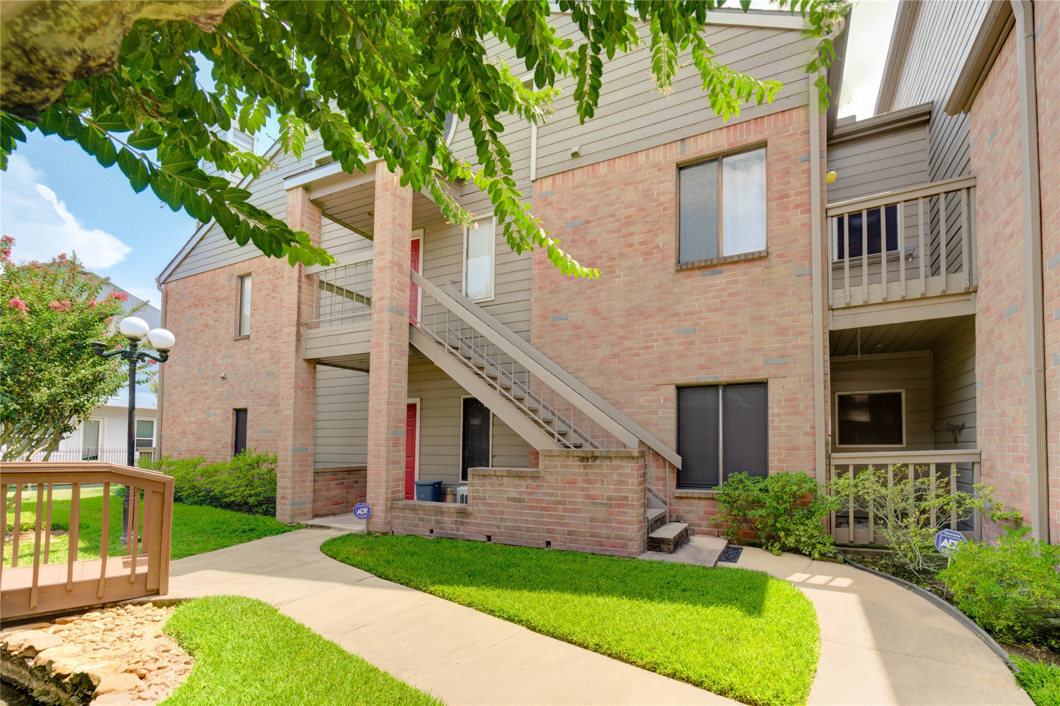2023 Gentryside Drive, Unit 202 Houston, TX 77077 - Photo 10 of 50 a front view of a house with a yard and garage