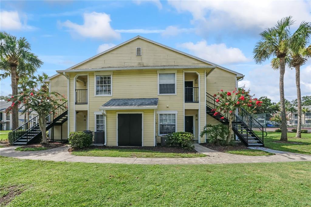1031 South Hiawassee Road, Unit 2518 Orlando, FL 32835 - Photo 1 of 1 a front view of a house with a garden and trees