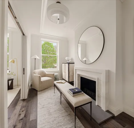 a living room with furniture a fireplace and a large window