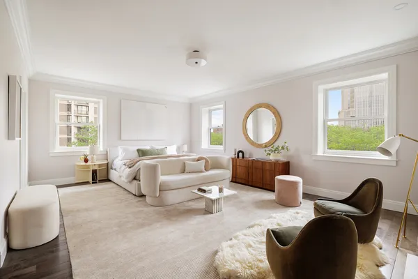 a living room with furniture a rug a window and a table