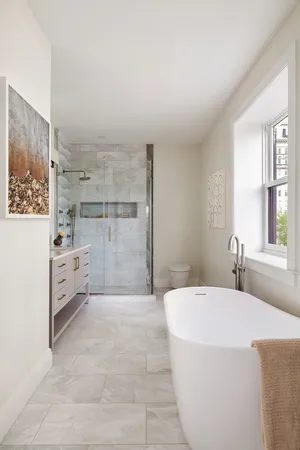 a spacious bathroom with a bathtub and a shower