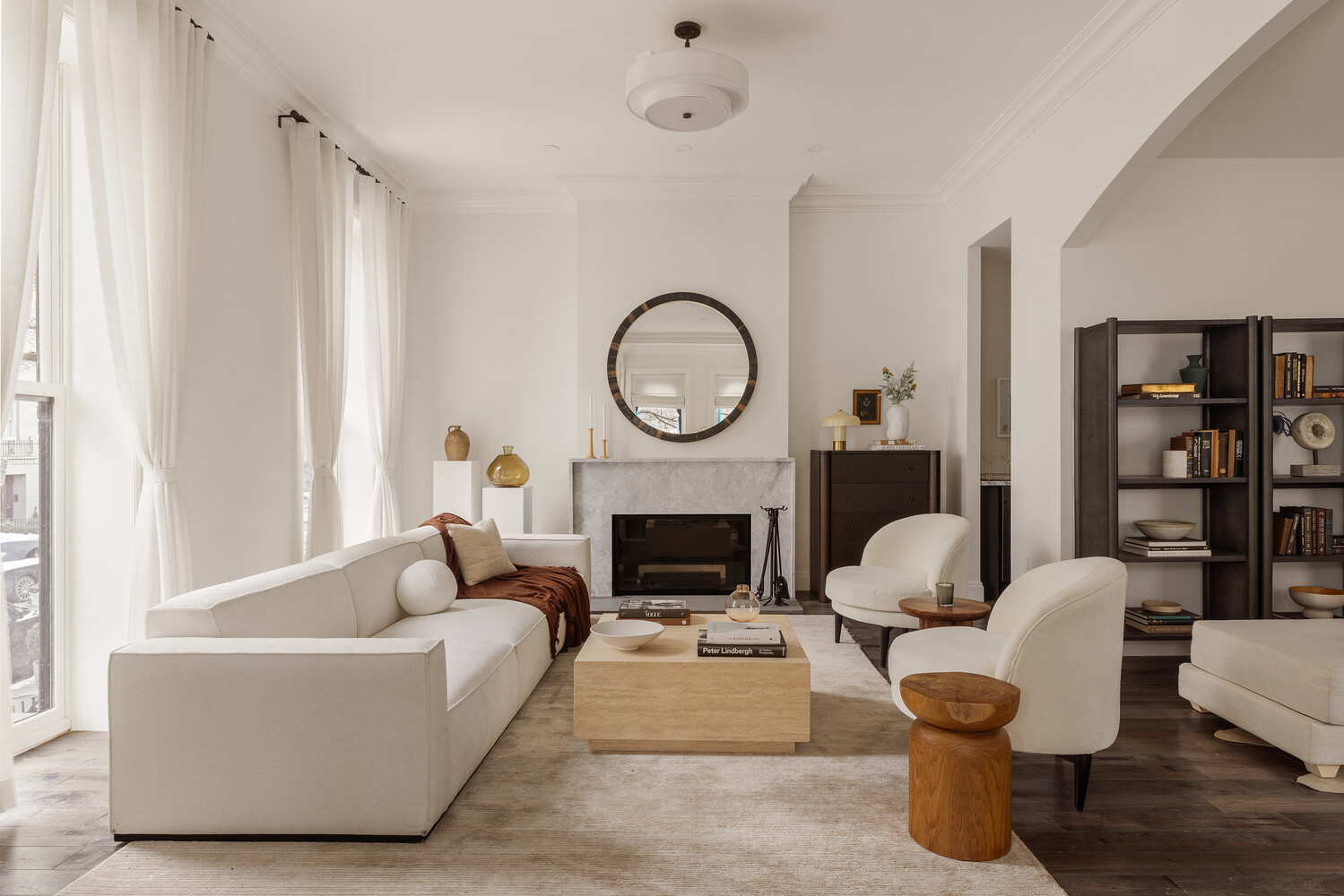 a living room with furniture a fireplace and a large window
