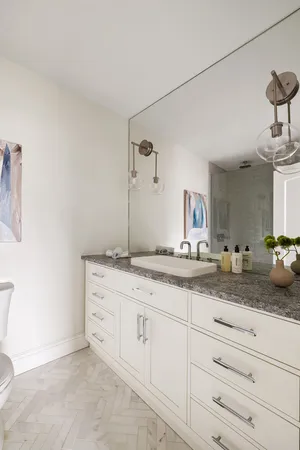 a bathroom with a granite countertop sink and a mirror