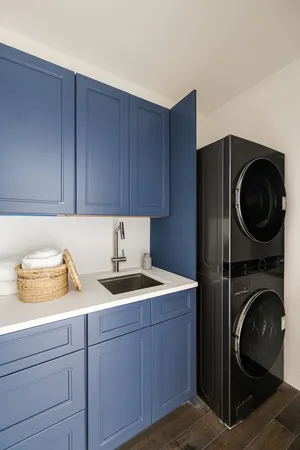a utility room with sink dryer and washer