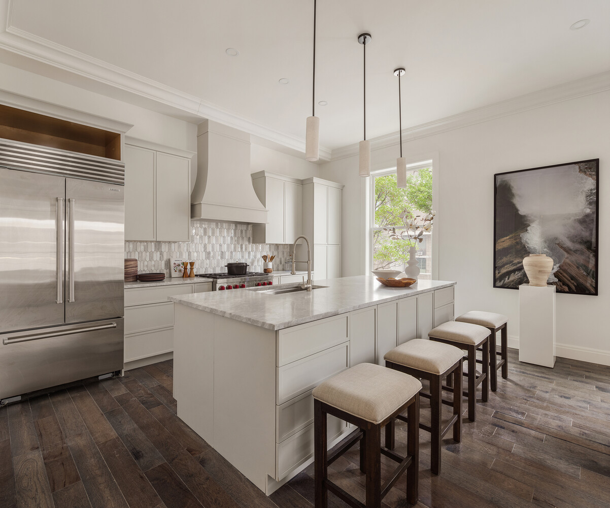 1 Monroe Place Brooklyn, NY 11201 - Photo 3 of 31 a kitchen with stainless steel appliances granite countertop a stove a refrigerator a microwave a dining table and chairs with wooden floor