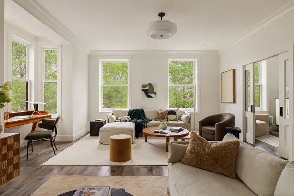 a living room with furniture and large windows