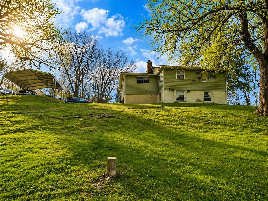 101 Fishpot Road Fredericktown, PA 15333 - Photo 19 of 21 a view of a tree in front of a house with a big yard