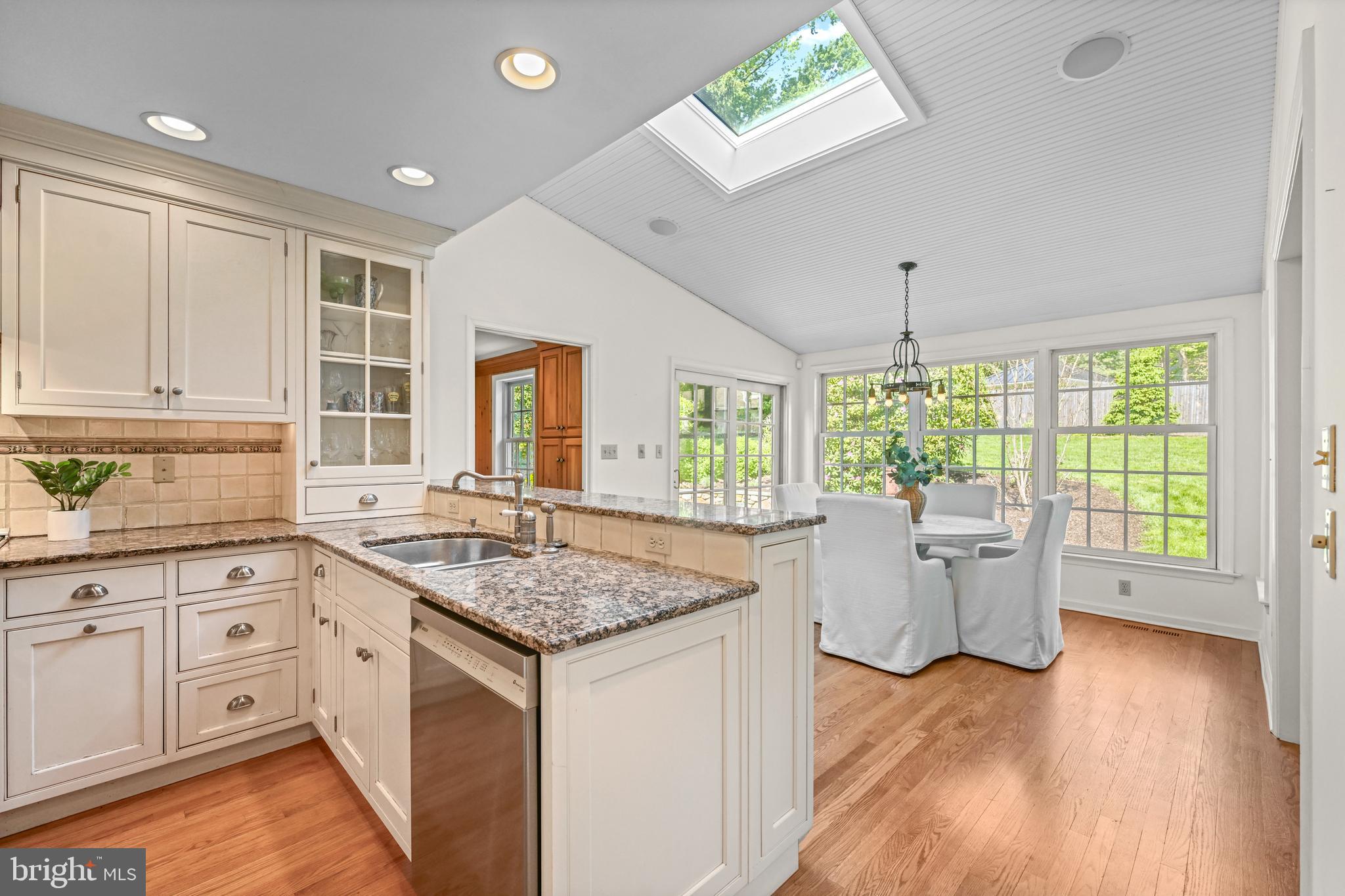 977 Ivycroft Road Wayne, PA 19087 - Photo 14 of 38 a kitchen with a center island wooden floor and a window