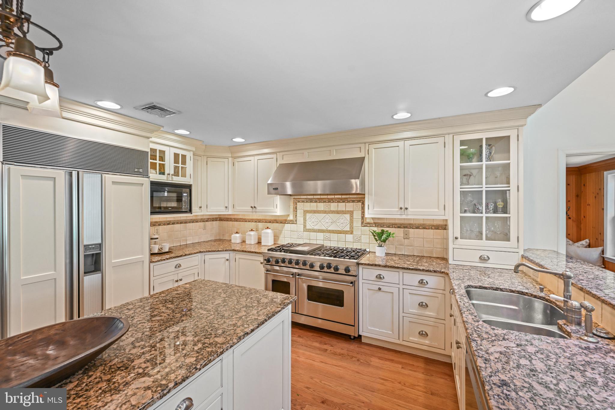 977 Ivycroft Road Wayne, PA 19087 - Photo 9 of 38 a kitchen with stainless steel appliances granite countertop a sink stove and refrigerator
