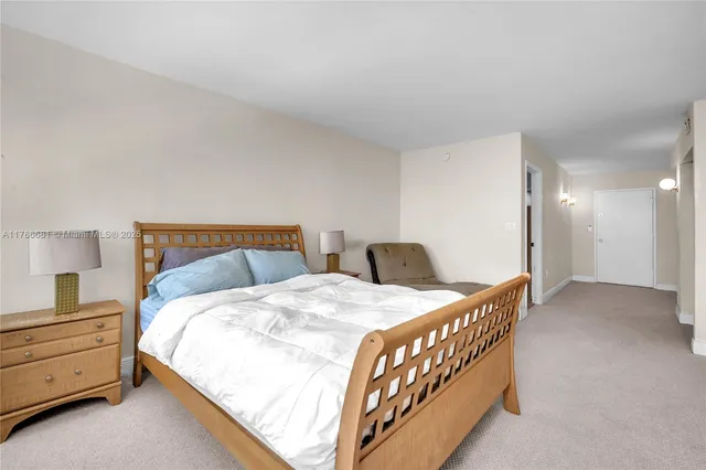 a bedroom with a bed and a lamp on table