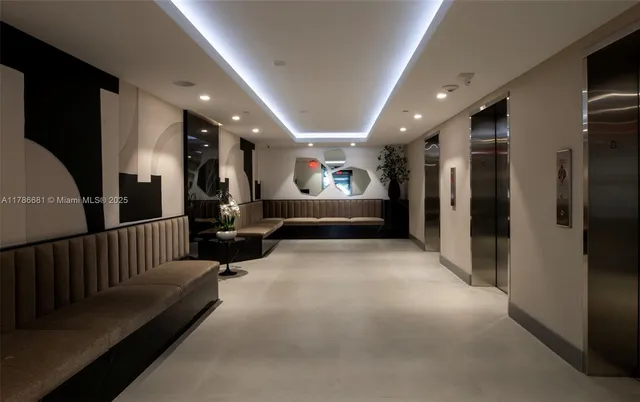 a room with pool table and large windows