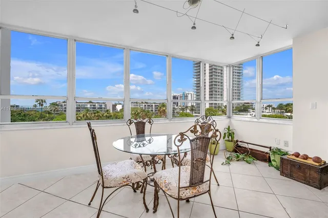 a dining room with furniture a chandelier and window