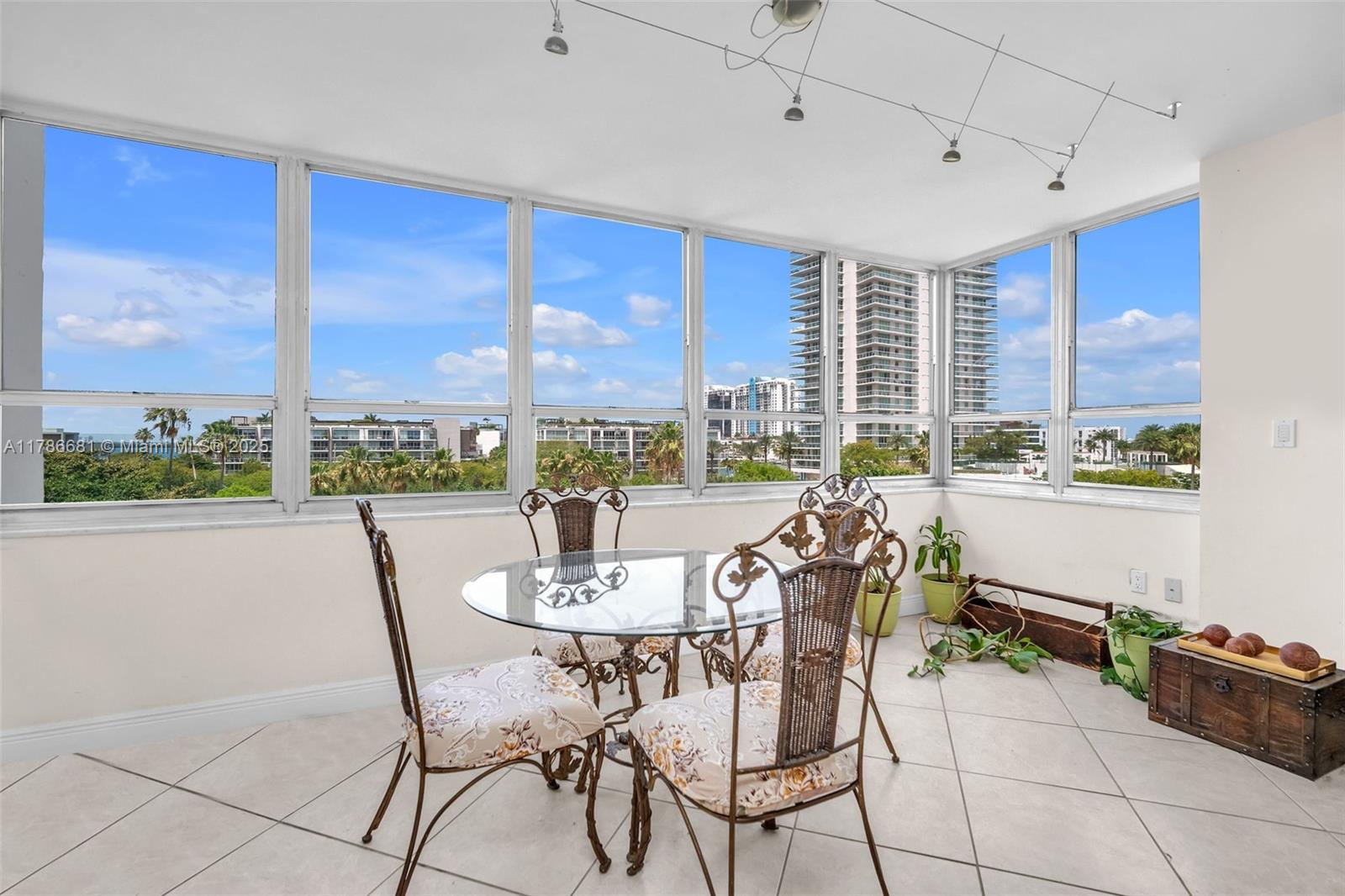 11 Island Avenue, Unit 512 Miami Beach, FL 33139 - Photo 5 of 54 a dining room with furniture a chandelier and window
