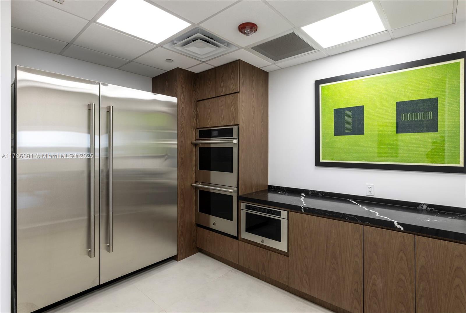 11 Island Avenue, Unit 512 Miami Beach, FL 33139 - Photo 51 of 54 a kitchen with stainless steel appliances granite countertop a refrigerator and a microwave