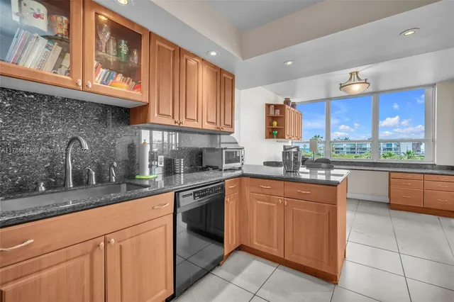 a kitchen with stainless steel appliances granite countertop stove top oven a sink dishwasher and granite countertops with cabinets