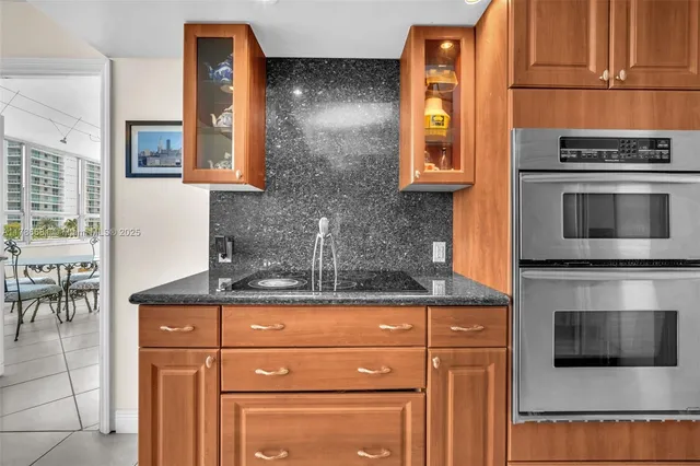 a kitchen with granite countertop cabinets stainless steel appliances and a counter space