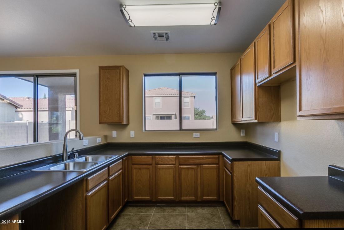 17025 West Rimrock Street Surprise, AZ 85388 - Photo 14 of 14 a kitchen that has a sink and a stove in it