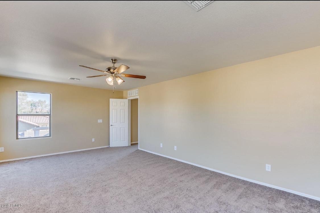 17025 West Rimrock Street Surprise, AZ 85388 - Photo 7 of 14 a view of an empty room with a window