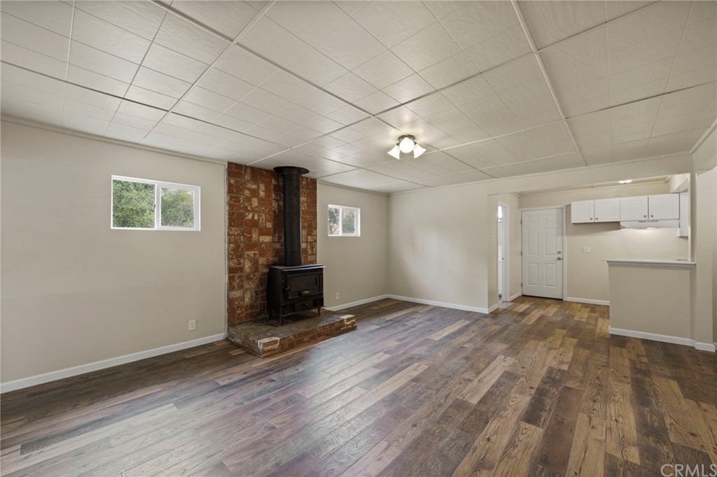 6436 Old Highway 53 Clearlake, CA 95422 - Photo 13 of 27 a view of a livingroom with wooden floor and a ceiling fan