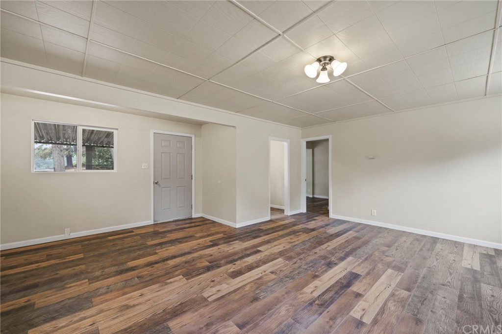 6436 Old Highway 53 Clearlake, CA 95422 - Photo 18 of 27 a view of an empty room with a window and a chandelier fan