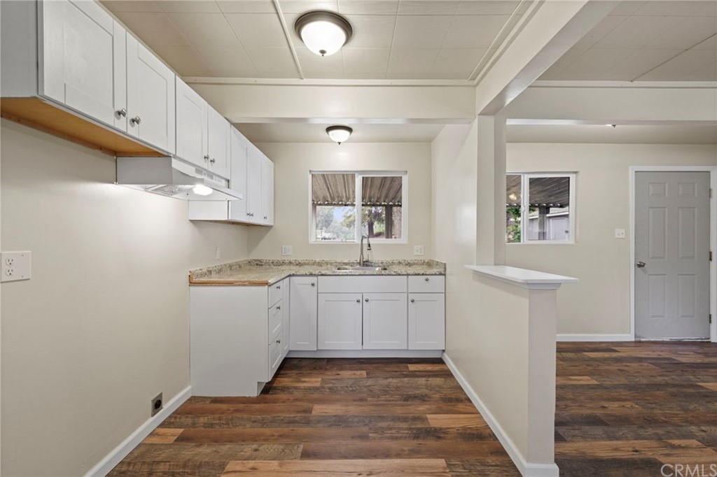 6436 Old Highway 53 Clearlake, CA 95422 - Photo 21 of 27 a kitchen with granite countertop white cabinets and white appliances