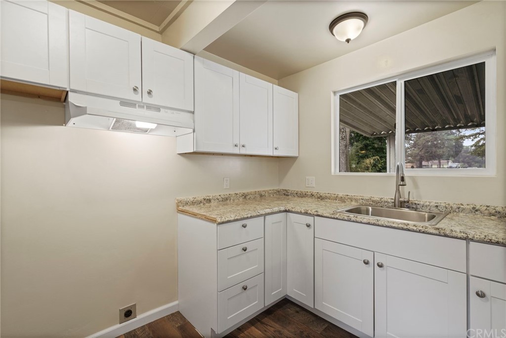 6436 Old Highway 53 Clearlake, CA 95422 - Photo 22 of 27 a kitchen with granite countertop white cabinets white appliances and sink