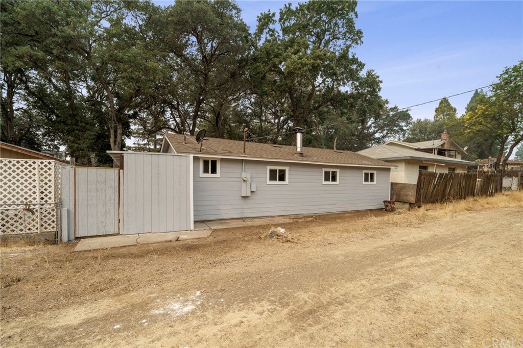 6436 Old Highway 53 Clearlake, CA 95422 - Photo 24 of 27 a view of a house with a large tree and wooden fence