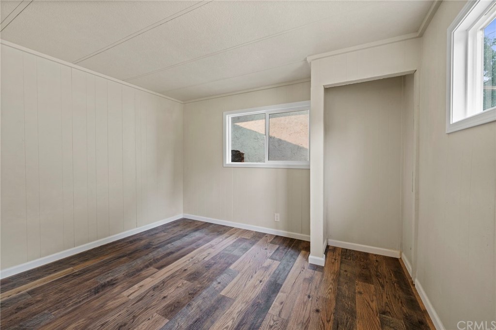 6436 Old Highway 53 Clearlake, CA 95422 - Photo 7 of 27 an empty room with wooden floor and windows