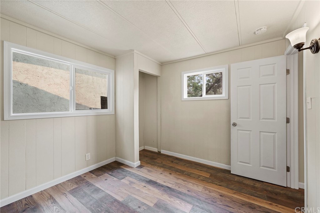 6436 Old Highway 53 Clearlake, CA 95422 - Photo 8 of 27 a view of an empty room with wooden floor and a window