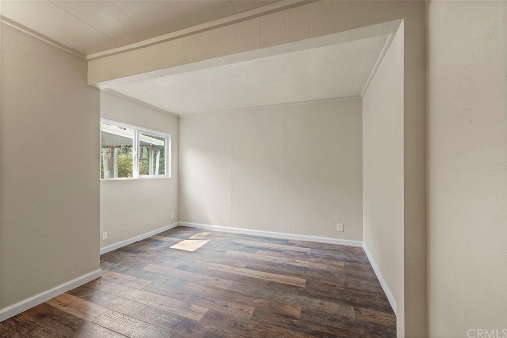 6436 Old Highway 53 Clearlake, CA 95422 - Photo 9 of 27 a view of an empty room with wooden floor and a window