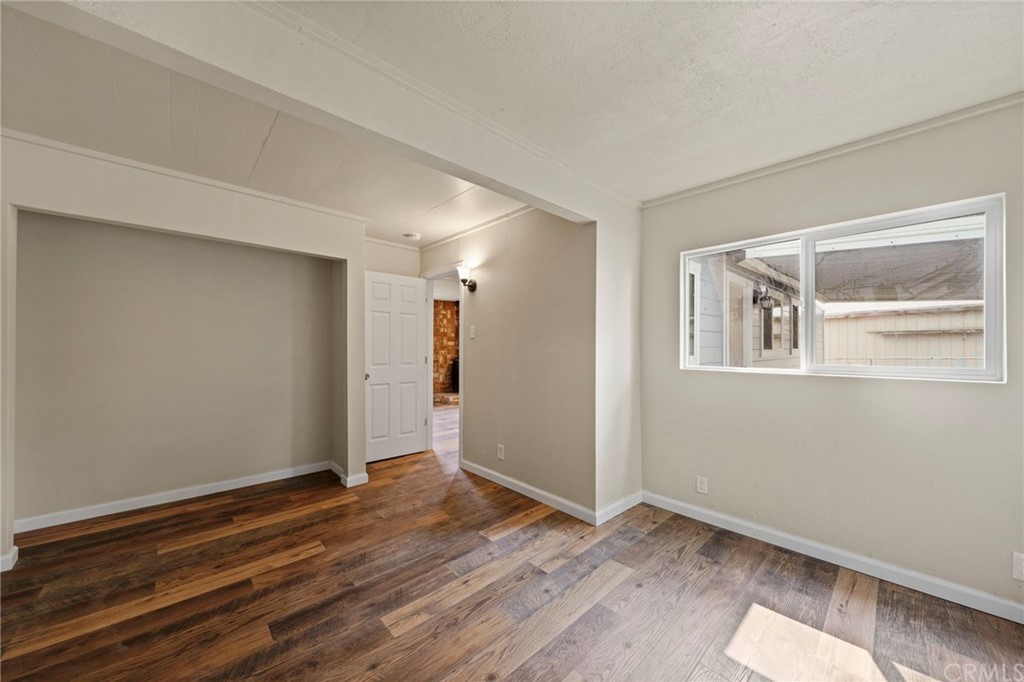 6436 Old Highway 53 Clearlake, CA 95422 - Photo 10 of 27 a view of an empty room with wooden floor and a window