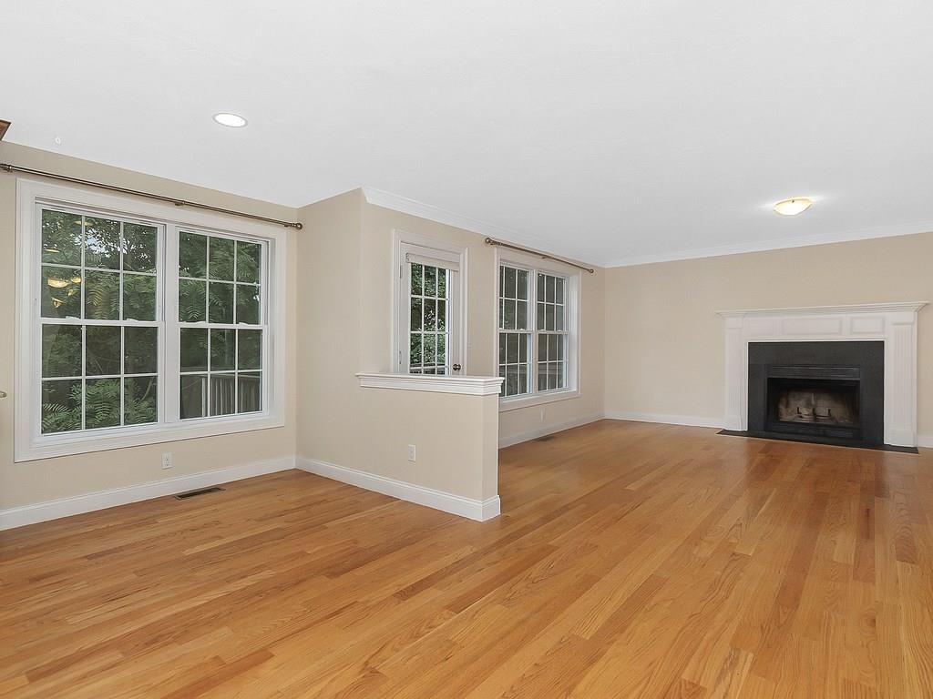 179 Florence Road Waltham, MA 02453 - Photo 11 of 37 a view of an empty room with wooden floor and a window