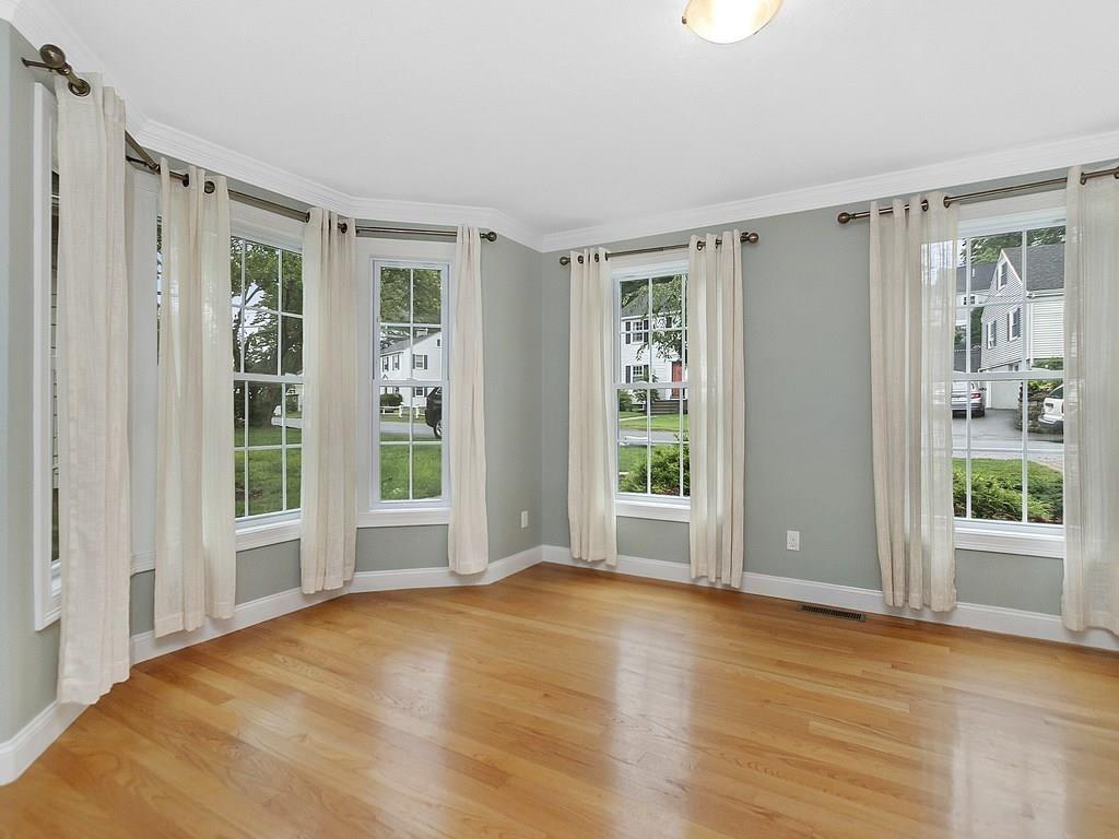 179 Florence Road Waltham, MA 02453 - Photo 12 of 37 a view of an empty room with wooden floor and a window