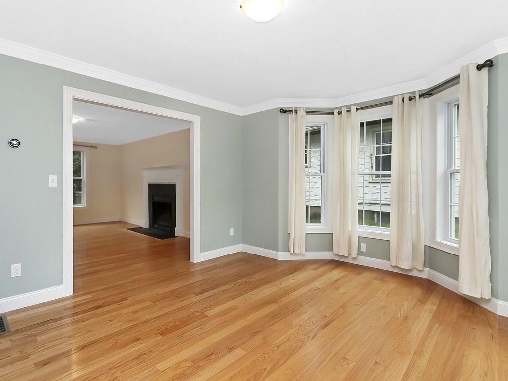 179 Florence Road Waltham, MA 02453 - Photo 13 of 37 a view of an empty room with wooden floor and a window