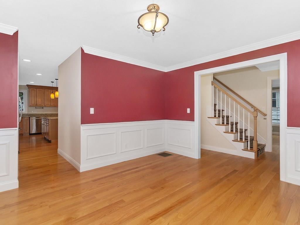 179 Florence Road Waltham, MA 02453 - Photo 15 of 37 a view of a hallway with wooden floor and staircase